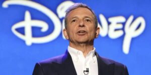 Bob Iger in front of the Disney logo