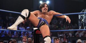 Joey Ryan creepily perched in a turnbuckle