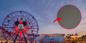 Pixar Pier at Disneyland. An image of a far away helicopter in the sky is in the forefront, searching for a culprit in a shooting outside the Disneyland entrance.