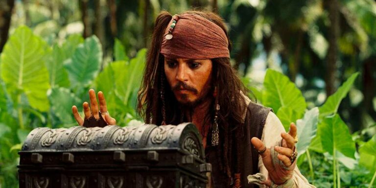 Johnny Depp as Captain Jack Sparrow looking inside a treasure chest in the 'Pirates of the Caribbean' franchise