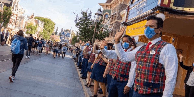 Cast Members waving down Main Street, U.S.A, at Disneyland Park in Disneyland Resort